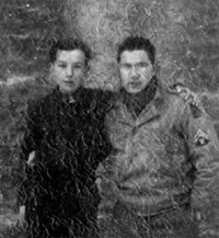 T/5 James Kromeke in his WW-II US Army uniform standing with Johnny, a unidentified Belgium boy, at Ensival, Belgium, circa January, 1945