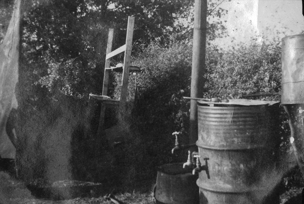 Photo of improvised field bathing facility constructed by US Army soldiers of 14th Chemical Maintenance Company, taken August-September 1944, near Nogent, France